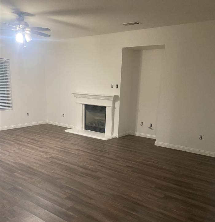 A beautifully transformed residential interior after a professional painting service. The walls now feature a fresh, modern color that brightens the space and complements the decor. The trim and ceiling have a crisp, clean finish, enhancing the overall aesthetic and making the room feel more spacious and inviting. The high-quality paint application ensures durability and a flawless, professional look.