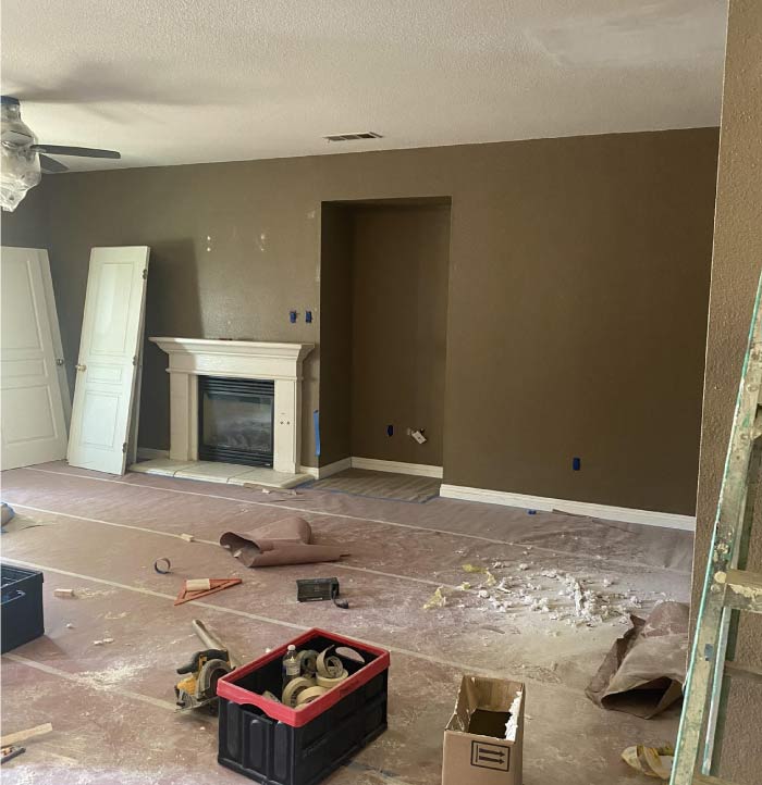 A residential interior room before painting, featuring dull, outdated wall colors with visible scuffs, stains, and minor cracks. The existing paint appears faded, making the space feel dim and uninviting. The trim and ceiling show signs of wear, lacking the crispness that a fresh coat of paint can provide. This image highlights the need for a professional interior painting service to refresh the space and enhance its overall ambiance