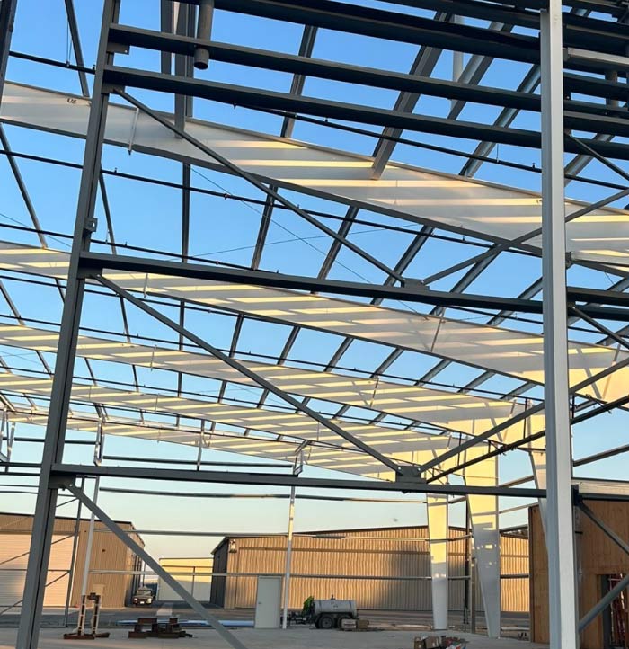 A commercial building's rooftop before professional painting, showing signs of wear, discoloration, and accumulated dirt. The roof surface appears weathered, with faded paint and visible rust or corrosion in certain areas. The lack of a fresh protective coating makes the structure look aged and vulnerable to further environmental damage. This image captures the need for a high-quality commercial roof painting service to restore durability and improve aesthetics.