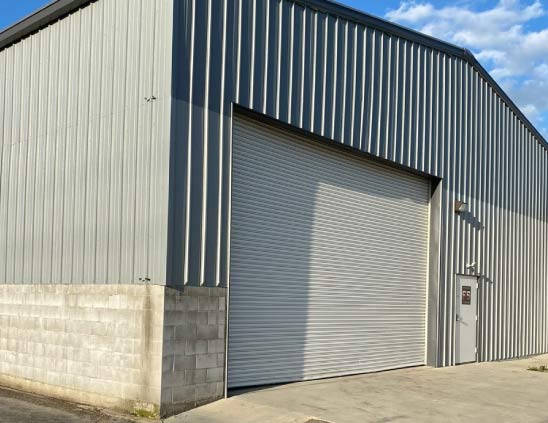 A long-lasting, weather-resistant paint finish on a commercial building, protecting it from the elements in Visalia, CA.