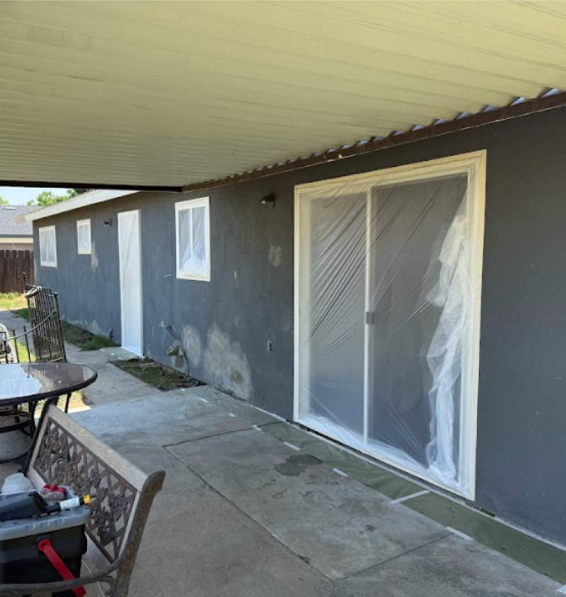 painting crew preparing a home's exterior to start house exterior painting project in fowler ca