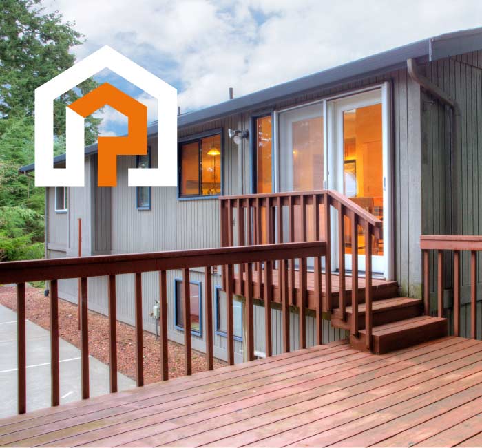 A large outdoor wooden deck and stairs featuring a rich reddish-brown stain finish that enhances the natural wood grain while providing protection from the elements.