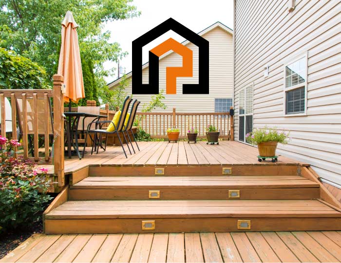 A spacious, multi-level residential deck with a warm honey-colored stain, featuring integrated step lighting and outdoor seating, showcasing high-quality wood restoration.